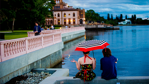 students sitting by a water