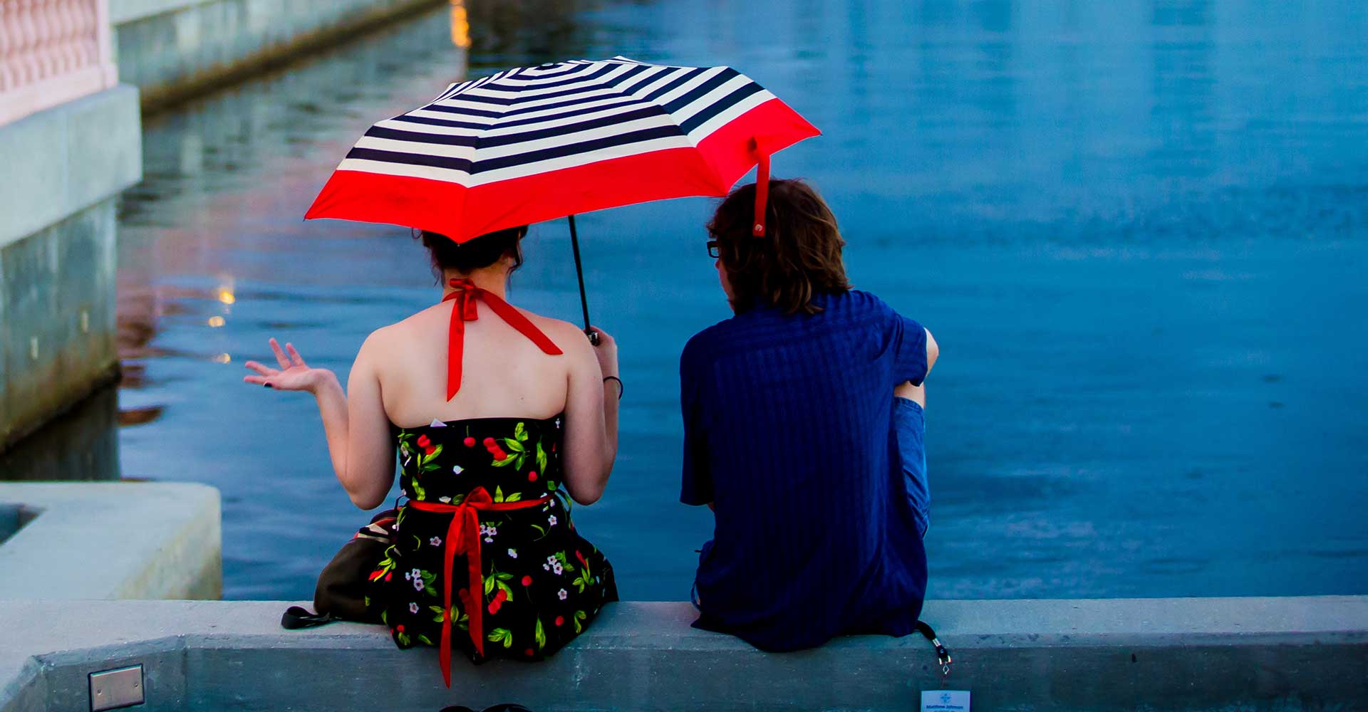 student sitting by a water